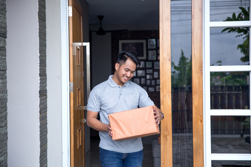 Man receiving an onboarding package at his front door
